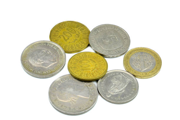 istock Silver and copper coins from around the world on isolated background 1136082602