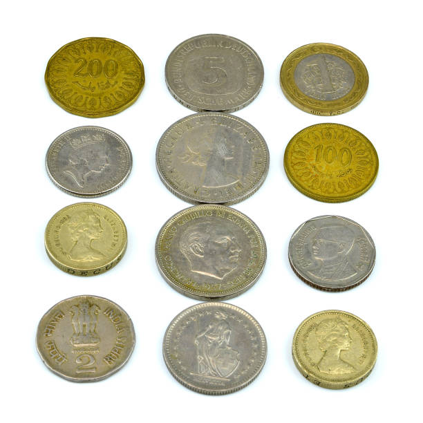 istock Silver and copper coins from around the world on isolated background 1136082632