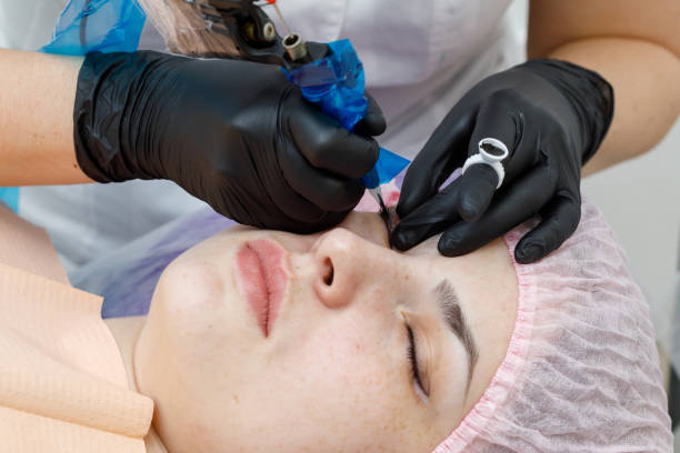 istock Permanent makup on face, woman having eyelid tattoo 1136085087