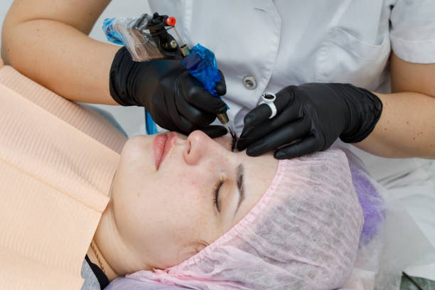 istock Permanent makup on face, woman having eyelid tattoo 1136085095
