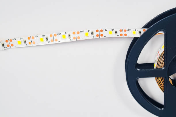 istock Diode strip. Led lights tape in roll on with background. 1136085145