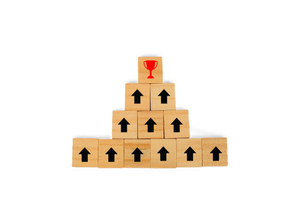 istock Wooden block with black arrow facing the direction to winner cup, Unique,work heard. 1136085147