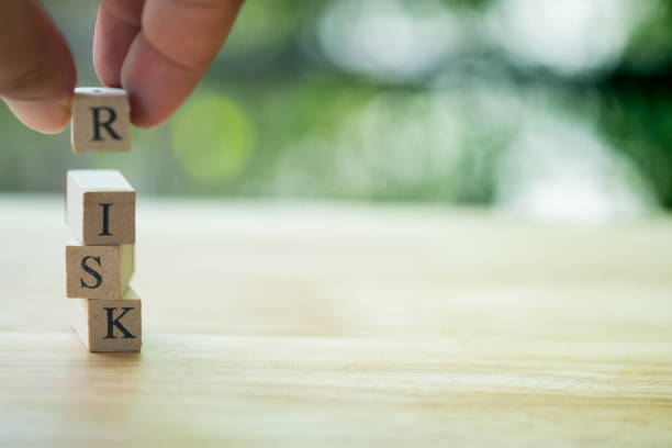 istock Hand placing or pulling wooden block text is Risk. Risk management 1136086266