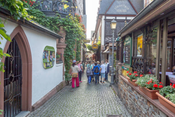 Rudesheim, Germany - September 2, 2014: People walking in the narrow and busy Drosselgasse of Rüdesheim in the wine growing Rheingau region in Hessen, Germany. (Rüdesheim am Rhein).