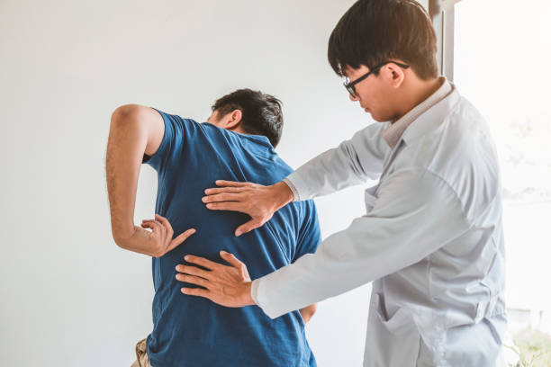 istock Physical Doctor consulting with patient about Back problems Physical therapy concept 1136089119