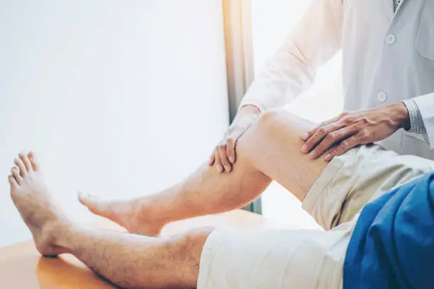 Photo of Physical Doctor consulting with patient Knee problems Physical therapy concept