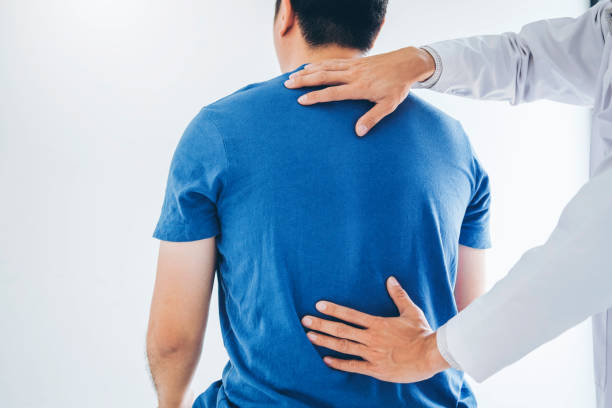 istock Physical Doctor consulting with patient about Back problems Physical therapy concept 1136089262