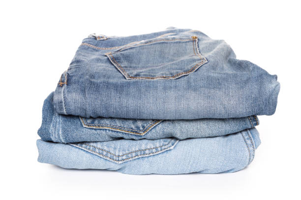 istock A stack of clothes jeans pants on a white background. Isolation 1136097606