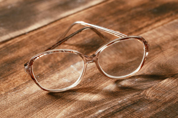 istock A pair of glasses on a wooden table 1136097684