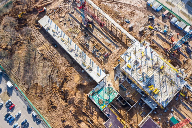 istock construction site in progress. busy building site with construction machinery. aerial photo 1136098696