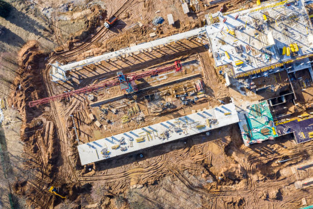 istock aerial view of building under construction with tower crane 1136098713