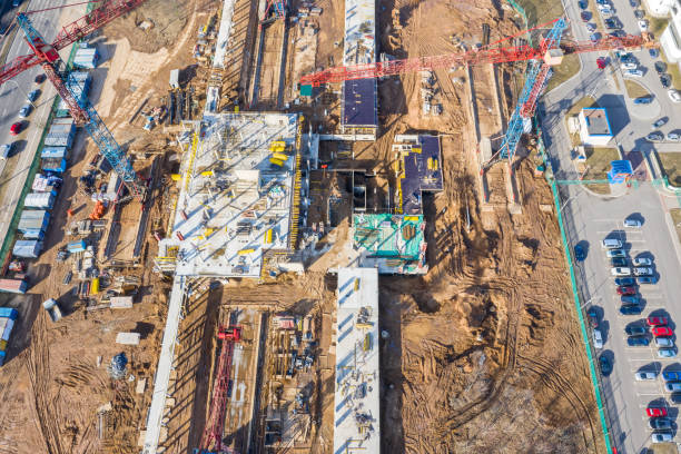 istock aerial view of building construction site with tower cranes 1136098719