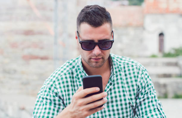 istock Man using cellphone outdoor in Budva Montenegro old town. 1136108843