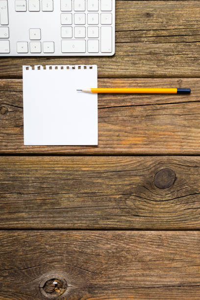 istock Note papers and keyboard on weathered wooden 1136109999