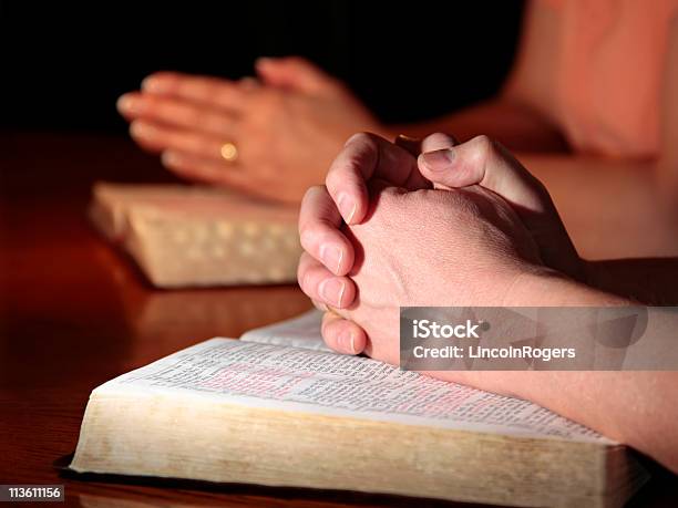 Man And Woman Praying With Holy Bibles Stock Photo - Download Image Now - Adult, Adults Only, Apostle - Worshipper