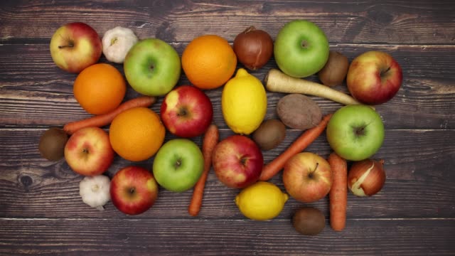 Vegetables and fruits on wooden table - Stop Motion