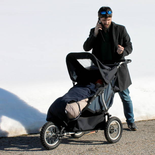 istock Father with stroller in the snow 1136123878