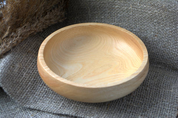 istock Empty wooden bowl on textile background Cozy house 1136131820
