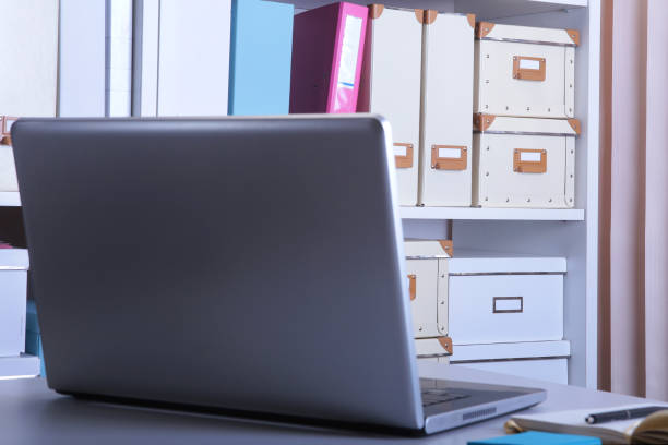 istock Modern office interior with laptop, chairs and bookcases 1136132067