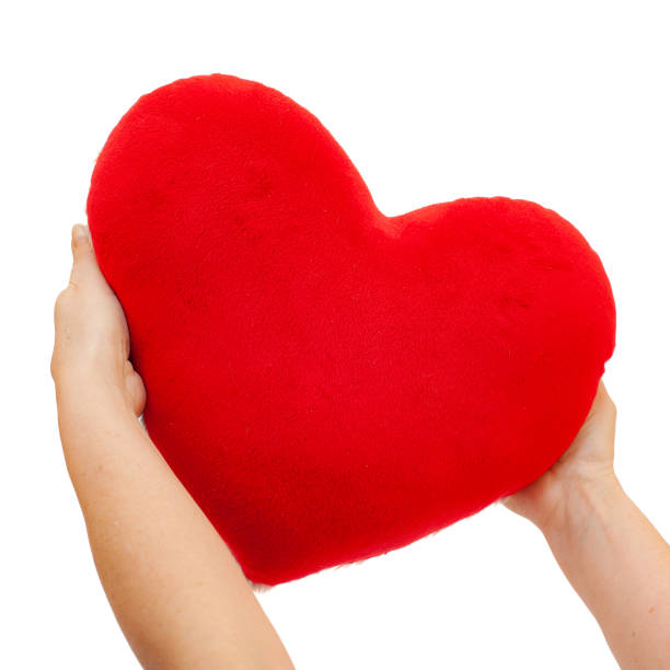istock Female hands holding red heart. Isolated on white background 1136133085