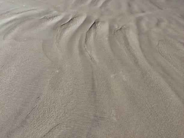 istock patterns from the waves and wind on the sand, sand of an unusual color 1136134575