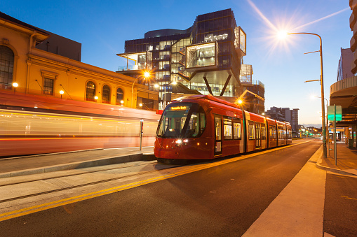 Newly installed light rail in Newcastle CBD Australia. Illuminated at dusk.