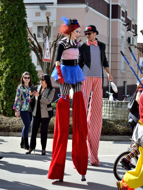 Svilajnac, Serbia - March 10, 2019 : Traditional Slavic festival. Carnival entertainment couple walking on stilts