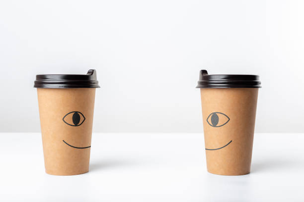 Two craft coffee cups with funny print isolated on white bakcground.