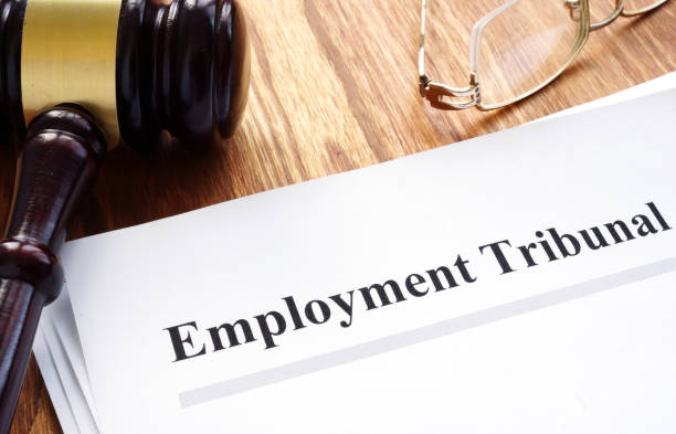 istock Employment tribunal documents with pen on table. 1136139260