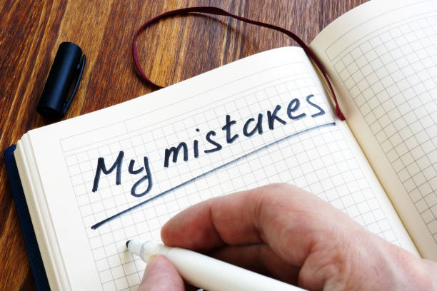 istock Man is writing My mistakes in a note. Inner critic concept. 1136139390