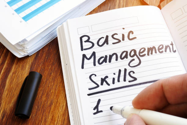 istock Man is writing list of Basic management skills. 1136139392