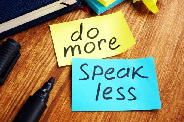 istock Do more speak less written on a color papers. 1136139449