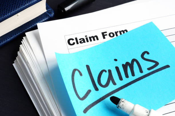 Stack of Claims applications on a desk. Stack of Claims applications on a desk. health insurance stock pictures, royalty-free photos & images