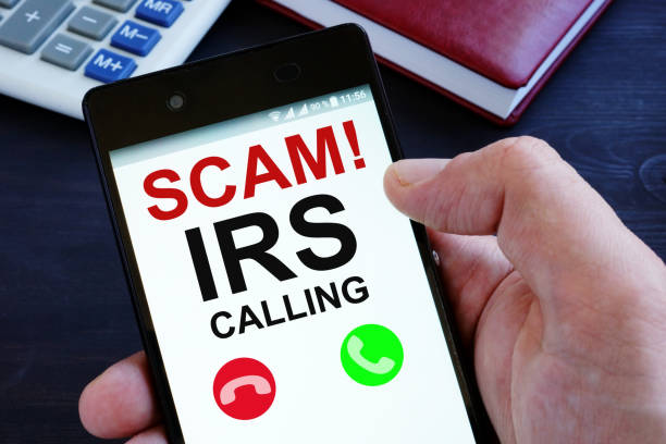 Hand is holding phone with irs scam calls. Hand is holding phone with irs scam calls. white collar crime stock pictures, royalty-free photos & images