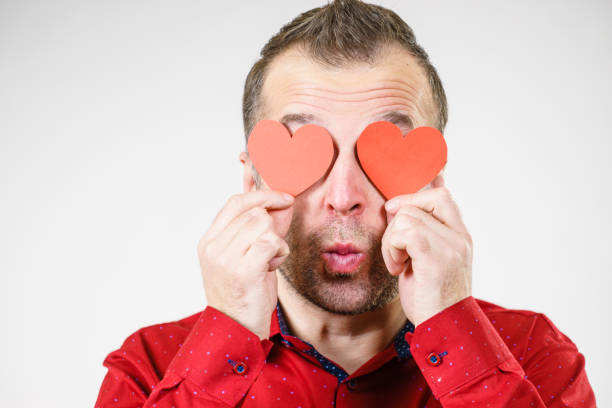 istock Man in love with hearts on eyes 1136142447