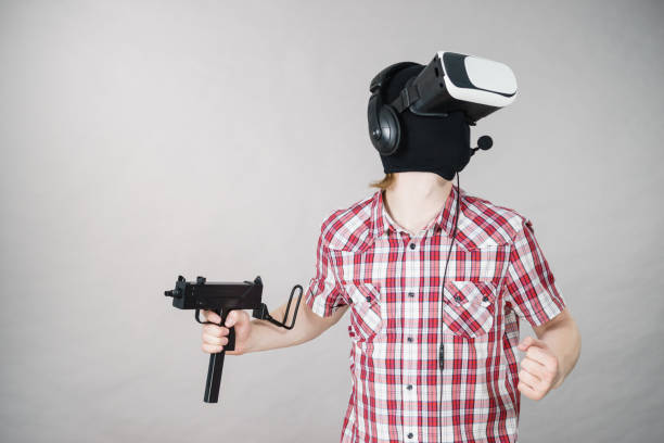 istock Gamer man wearing VR holding gun 1136142522