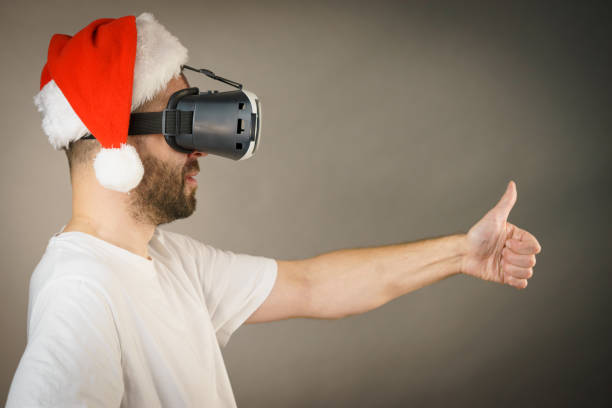 istock Man in virtual reality goggles and santa hat 1136142546