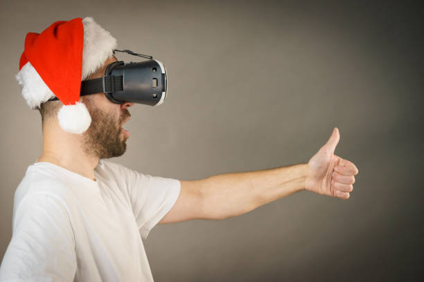 istock Man in virtual reality goggles and santa hat 1136142641