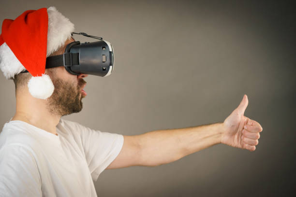 istock Man in virtual reality goggles and santa hat 1136142668