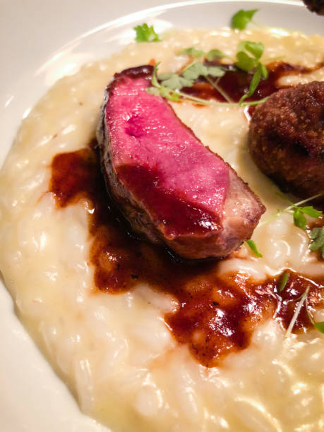 istock italian risotto & fried pigeon with berry reduction 1136143708