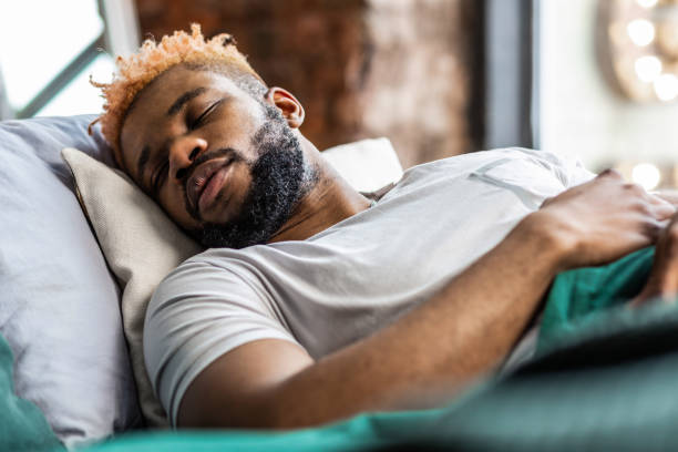 istock Handsome African American man lying on his bed 1136143731