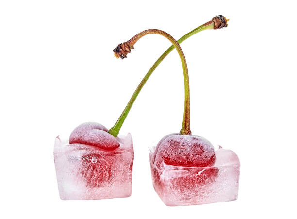 istock Two frozen cherries isolated on white background. Cherries in ice cubes. 1136144152