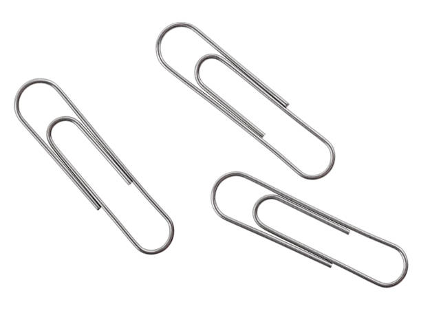 istock Three silver paper clips isolated on a white background. Top view. 1136144153