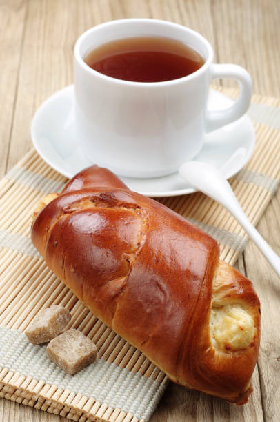 istock Sweet bun and cup of tea 1136149363