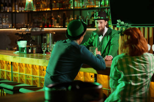 istock Dark-haired bearded young man in a leprechaun hat looking enigmatic 1136151734