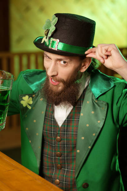 istock Dark-haired bearded young man in a leprechaun hat feeling great 1136151761