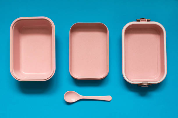 istock Empty pink bento lunch box with spoon on blue background 1136152093