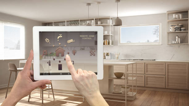 istock Smart remote home control system on a digital tablet. Device with app icons. Minimalist modern bright kitchen in the background, architecture interior design 1136156811