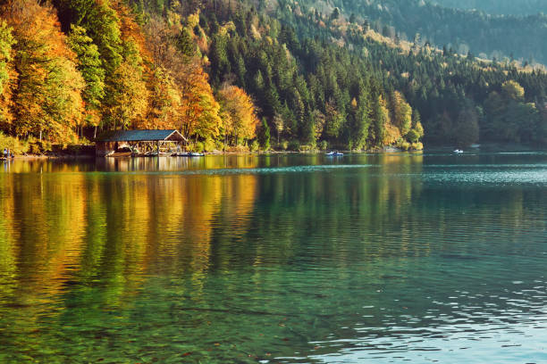 istock Beautiful blue mountain lake on a warm fall season day 1136157902