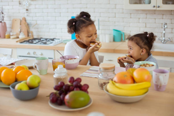 istock Cheerful international kids enjoying their healthy breakfast 1136159607